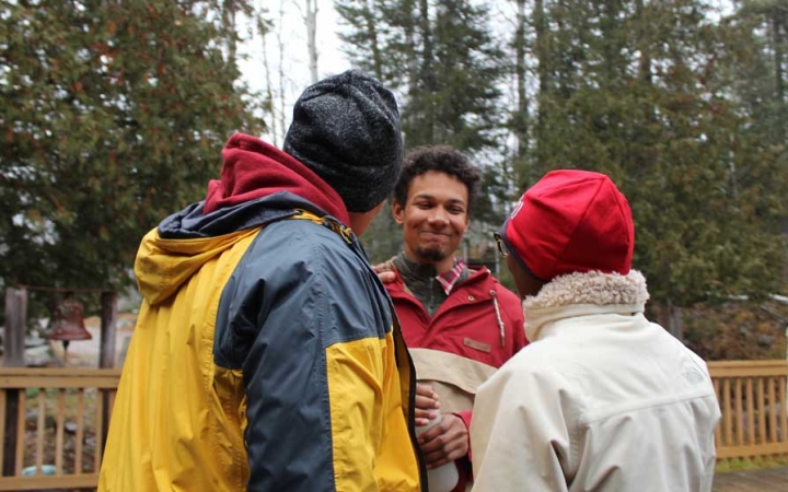 Three people speak to each other at the family seminar of an outward bound intercept course